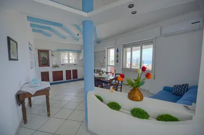 a living room with a couch and a table at Villa Cielo d'Alcamo Marina in Alcamo