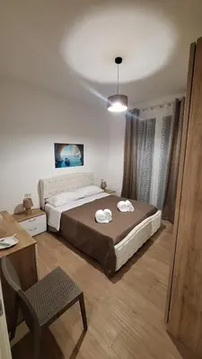 a bedroom with a bed and a table and a chair at Siciliano Palace - Deluxe Apartments & Spa in Bagheria