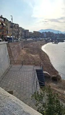 a sandy beach with stairs leading down to the water at Siciliano Palace - Deluxe Apartments & Spa in Bagheria
