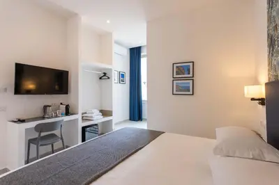 a hotel room with a bed and a desk at URBAN Palermo DOWNTOWN in Palermo