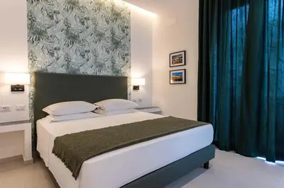 a bedroom with a large bed with a green headboard at URBAN Palermo DOWNTOWN in Palermo