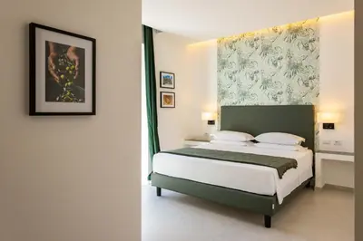 a bedroom with a bed and a painting on the wall at URBAN Palermo DOWNTOWN in Palermo