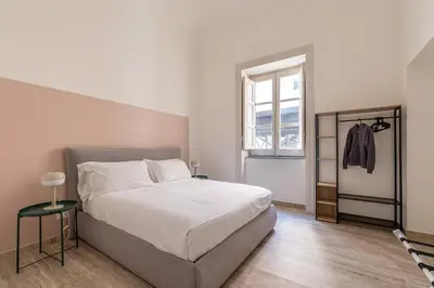a bedroom with a large bed and a window at Central City Apartment by Wonderful Italy in Palermo