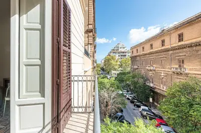 an apartment balcony with a view of a street at Central City Apartment by Wonderful Italy in Palermo