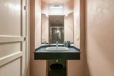 a bathroom with a sink and a mirror at Central City Apartment by Wonderful Italy in Palermo