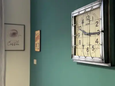 a clock is hanging on a blue wall at BB Essenze Club in Palermo