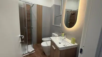 a bathroom with a sink and a toilet and a mirror at BB Essenze Club in Palermo