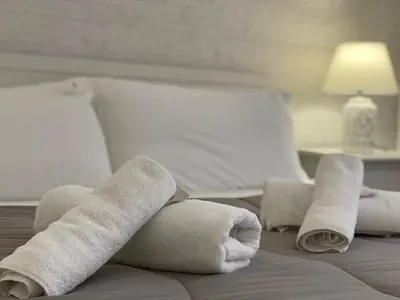 a hotel room with rolled towels on a bed at BB Essenze Club in Palermo