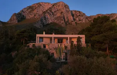 a house in the middle of a mountain at Modernist Villa With Private Sea Access in Bagheria