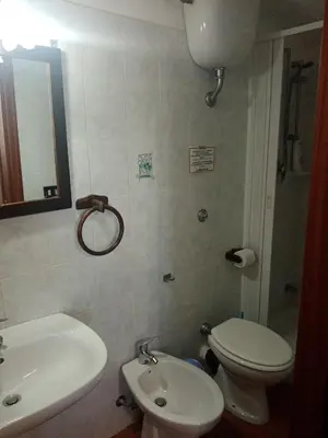 a bathroom with a white toilet and a sink at Casa Siciliana Altarbiah in Trabia