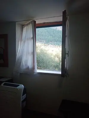 a window in a room with a view of a field at Casa Siciliana Altarbiah in Trabia