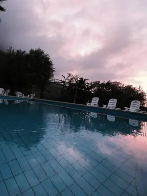 a large swimming pool with chairs at Casa Siciliana Altarbiah in Trabia