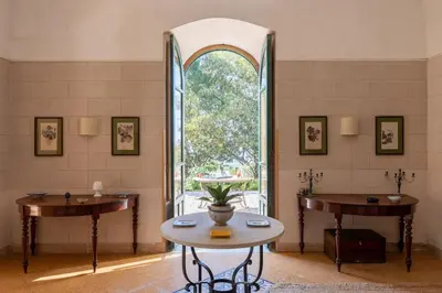a room with two tables and a large window at Baglio del Grillo in Grisi