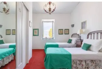 a room with two beds with green sheets at Baglio del Grillo in Grisi