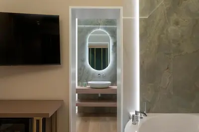 a bathroom with a sink and a mirror at Isidoro Luxury Suites in Palermo