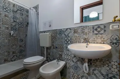 a bathroom with a sink and a toilet and a sink at GuestHouse - 21 Steps to Everywhere in Palermo in Palermo