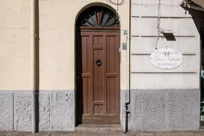 a brown door on the side of a building at GuestHouse - 21 Steps to Everywhere in Palermo in Palermo