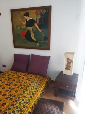 a bedroom with a bed with a painting on the wall at dimora sammartino in Palermo
