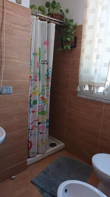 a bathroom with a toilet and a shower curtain at dimora sammartino in Palermo