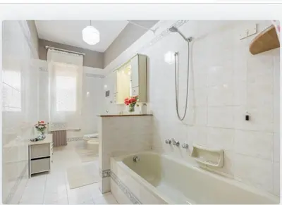 a white bathroom with a tub and a shower at incantevole casa vacanze myu in Cinisi