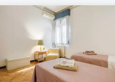 a hotel room with two beds and a window at incantevole casa vacanze myu in Cinisi