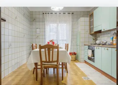 a kitchen with a table and chairs in a room at incantevole casa vacanze myu in Cinisi