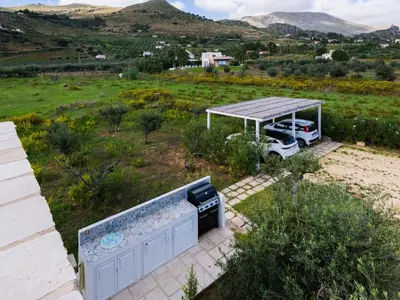 an aerial view of a house with a grill and a car at Villa Aura Scopello in Castellammare del Golfo