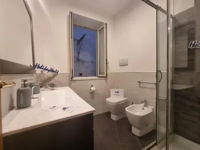 a bathroom with a sink and a toilet and a shower at DownTown House by Holiday World in Palermo