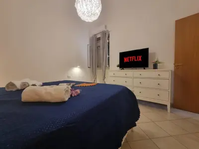 a bedroom with a bed and a tv on a dresser at DownTown House by Holiday World in Palermo