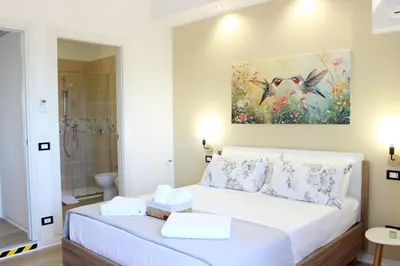 a bedroom with a bed and a painting on the wall at Dante Prime Collection Palermo in Palermo