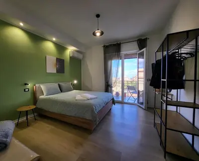 a bedroom with a bed and a sliding glass door at Dante Prime Collection Palermo in Palermo