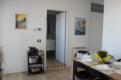 a dining room with a table and a kitchen at Dante Prime Collection Palermo in Palermo