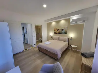 a large bedroom with a bed and a bathroom at Dante Prime Collection Palermo in Palermo