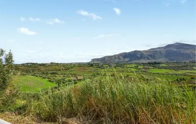a view of a field with mountains in the background at Villa Bruno in Castellammare del Golfo