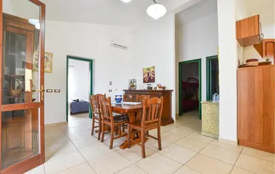 a kitchen and dining room with a table and chairs at Villa Bruno in Castellammare del Golfo