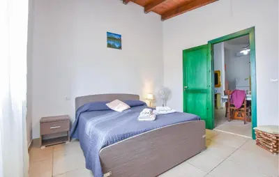 a bedroom with a bed and a green door at Villa Bruno in Castellammare del Golfo