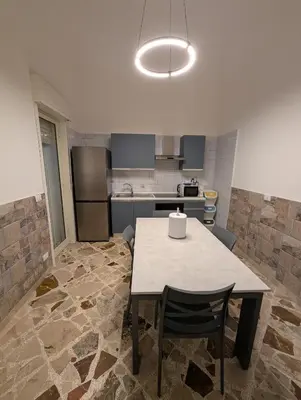 a kitchen with a table and chairs in it at Settebello - Lolli in Palermo