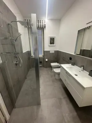 a bathroom with a shower and a sink and a toilet at Granatelli Apartment in Palermo