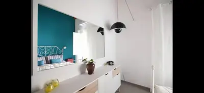 a bathroom with white counters and a blue wall at Casa Cutó near Central Station in Palermo