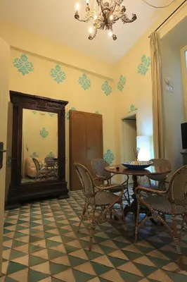 a living room with a table and chairs and a couch at Trinacria Home in Palermo