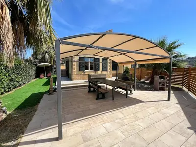 a pavilion with a picnic table under a canopy at Villa Stromboli - Le Ville del Mediterraneo in Campofelice di Roccella