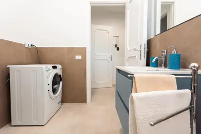 a laundry room with a washer and dryer at La Dimora di Icaro - near the sea, the Airport and Palermo in Carini
