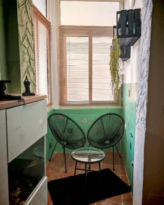 a kitchen with two chairs and a table and a window at Guest House Scalia in Palermo