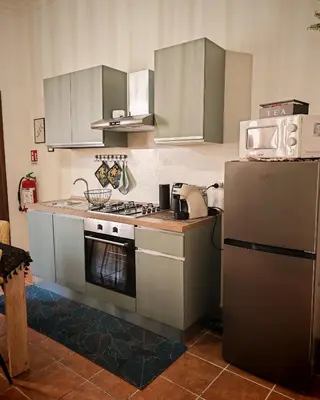 a kitchen with a stove and a refrigerator at Guest House Scalia in Palermo