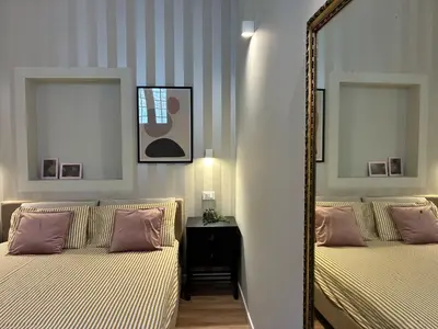a bedroom with two beds and a mirror at Vista Cattedrale - City Center in Palermo