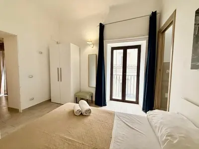 a bedroom with a large bed and a window at Dimora Sant'Agostino 2 in Palermo