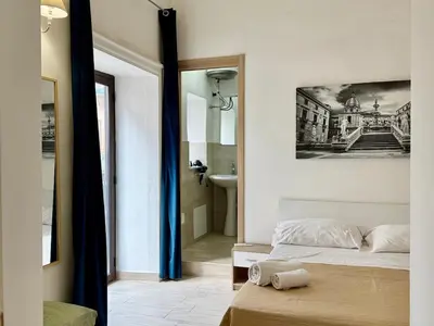 a bedroom with a bed and a bathroom at Dimora Sant'Agostino 2 in Palermo