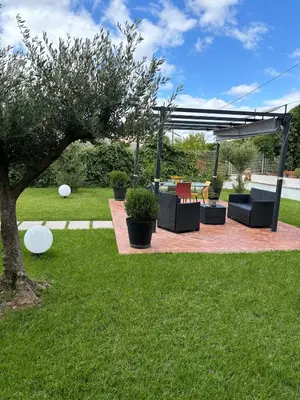 a table and chairs on a balcony with an umbrella at Exclusive Villa with Pool Near Monreale in Monreale