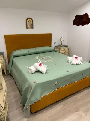 a bedroom with a bed with two pairs of shoes on it at Exclusive Villa with Pool Near Monreale in Monreale