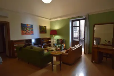 a living room with two couches and a table at Carlita's Home in centro storico a Palermo in Palermo